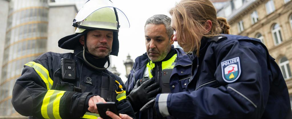 Public Safety officer looking at a mobile terminal