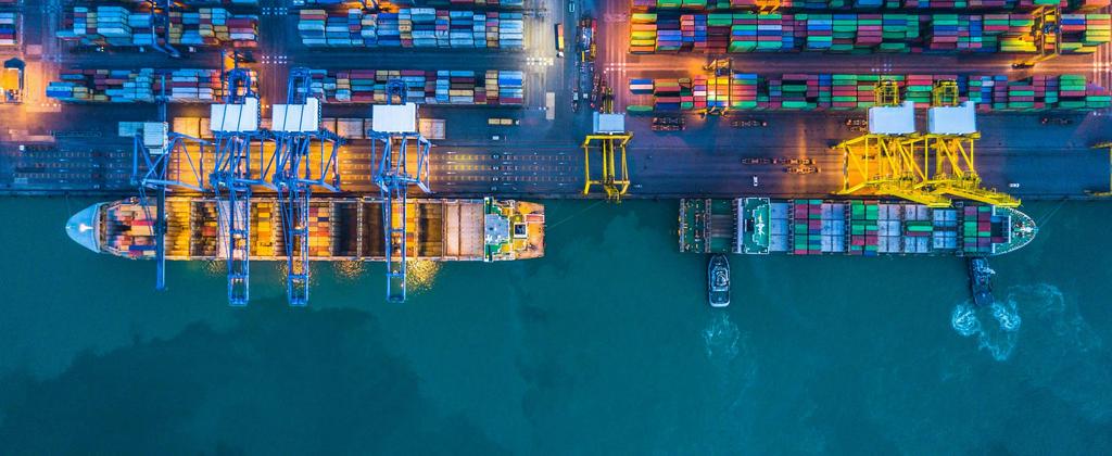 Overhead perspective of a container ship loaded with various cargo containers, showcasing maritime logistics. 