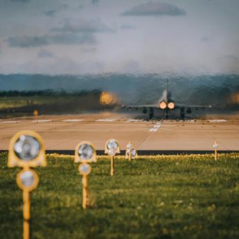 Starting airplane on a runway (view from behind)