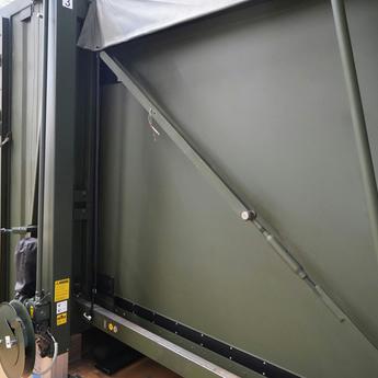 Close-up of an extended 1:3 container-based mobile command post from outside, focused on the entrance and one of the extended sites. 