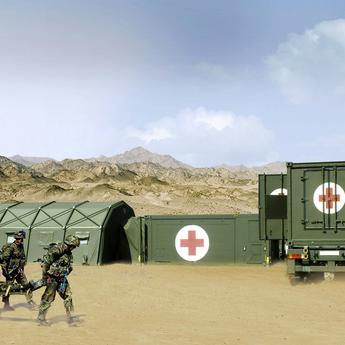 Aerial photograph of a Role Two Rescue Centre in the field, consisting of interconnected tents and containers.