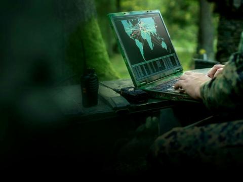 Soldier on computer analysing potential threats