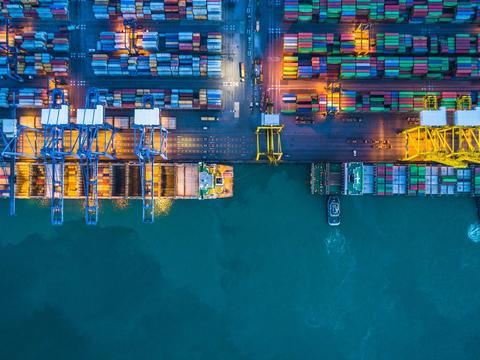 Overhead perspective of a container ship loaded with various cargo containers, showcasing maritime logistics.
