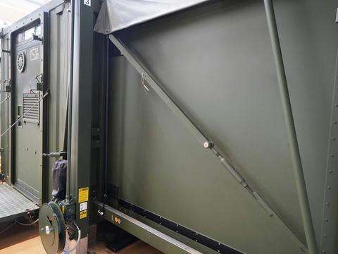Close-up of an extended 1:3 container-based mobile command post from outside, focused on the entrance and one of the extended sites. 