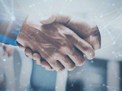 Close-up of a handshake from two men wearing business shirts. Around it you can see digital-looking dots and connecting lines. The image has a modern, technical and digital look and feel and is decorated in blue tones.