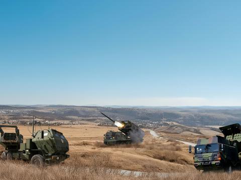  Military vehicles like rocket launchers in a rough landscape