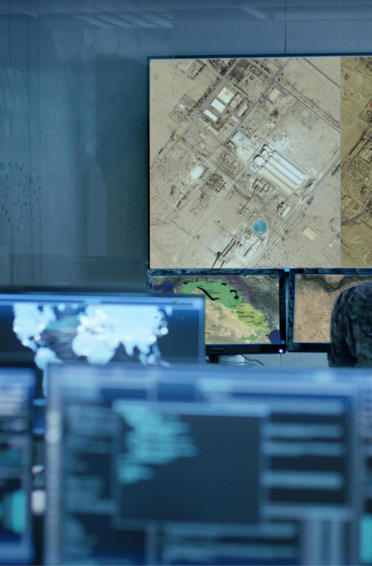 Military man analysing satellite imagery for Intelligence operations Military man analysing satellite imagery for Intelligence operations